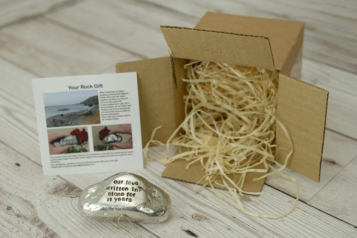 21st anniversary tin rock keepsake — handmade in Cornwall, shown with packaging shavings