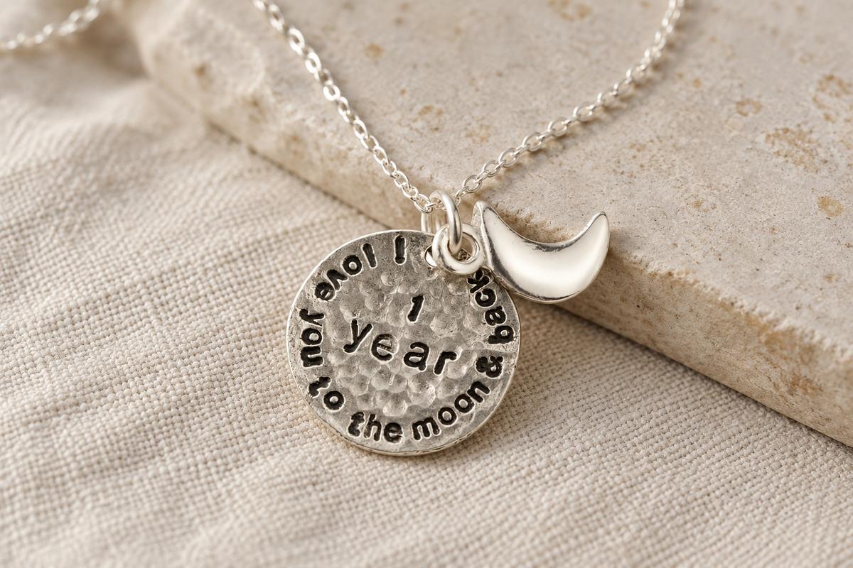 1st anniversary necklace — hammered silver disc pendant stamped 'I love you to the moon and back' with crescent moon charm